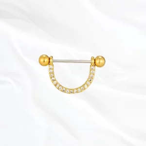 Piercing de téton forme étrier doré "le delicat" pavé de cristaux transparents.