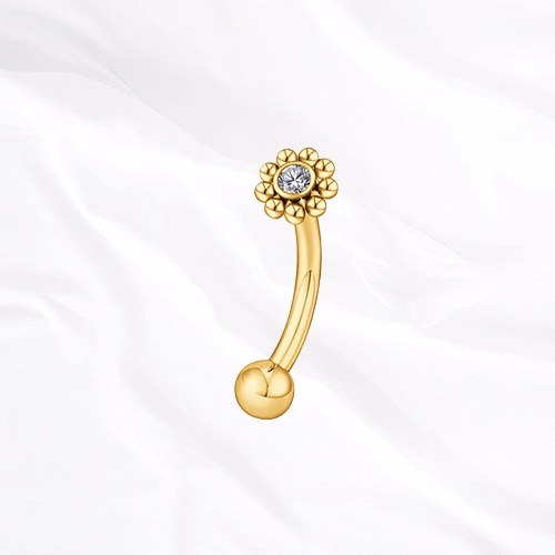 Piercing banane en titane doré Le Tournesol, couronne de billes de titane autour d’un zircon, montée au sommet d’une tige courbée