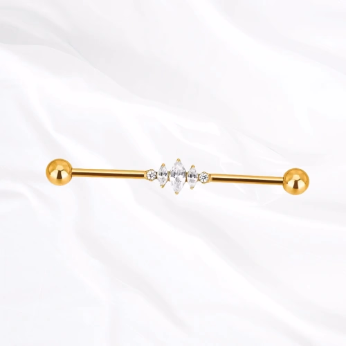 Barre industrielle en titane doré L’Ondulante, un zircon rond, une grande marquise puis un second rond alignés sur la tige