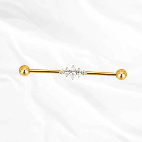 Barre industrielle en titane doré L’Ondulante, un zircon rond, une grande marquise puis un second rond alignés sur la tige