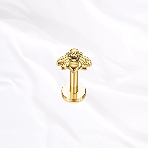 Labret en titane doré L’Abeille, abeille entièrement sculptée dans le titane, corps strié et ailes lisses déployées