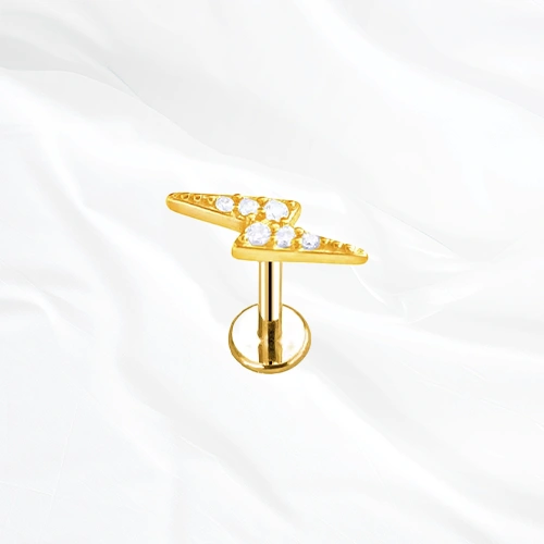 Labret en titane doré L’Éclair, éclair en deux branches brisées pavé de petits zircons suivant la ligne en zigzag