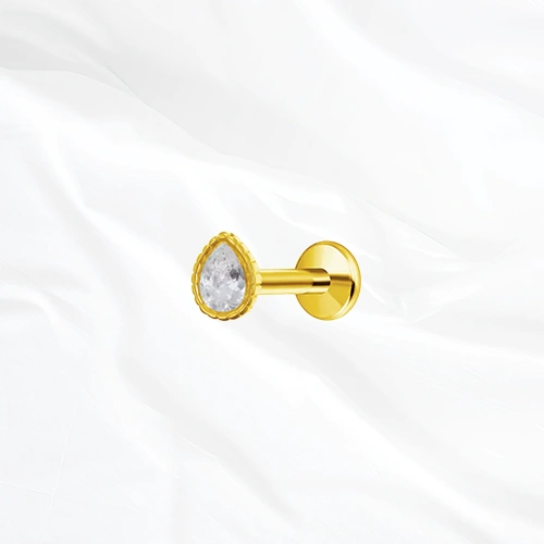 Labret push-in en titane doré L’Obélisque, zircon taille poire serti clos dans une monture bordée de fines billes