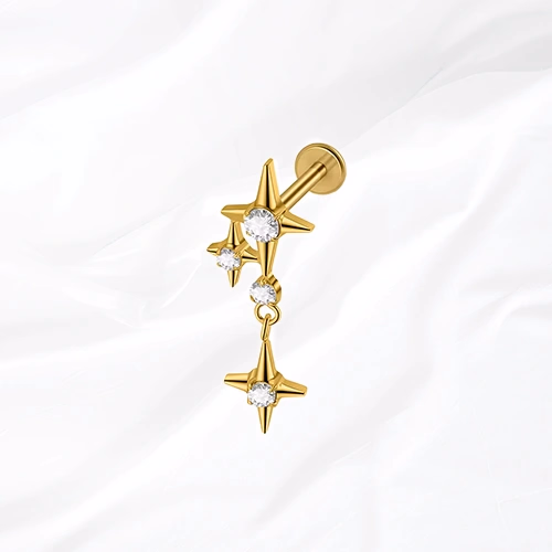 Labret en titane doré La Constellation, deux étoiles à quatre branches serties reliées par deux petites pierres