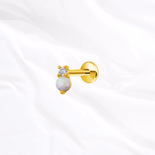 Labret push-in en titane doré Le Nacre, un zircon facetté et une perle d’imitation blanche et opalescente côte à côte