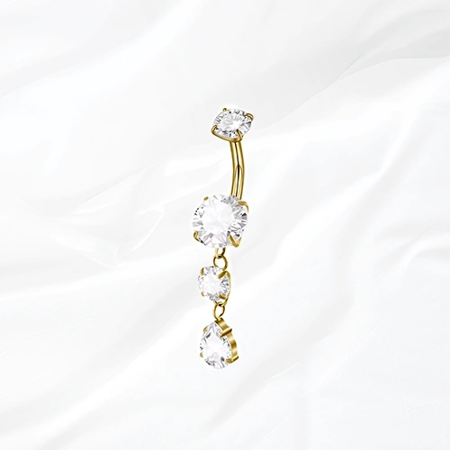 Piercing de nombril banane en titane doré La Cascade Précieuse, trois zircons suspendus en cascade