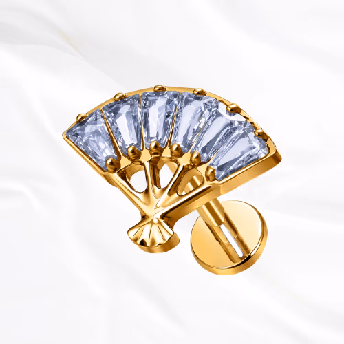Labret en titane doré L’Éventail, cinq zircons taille baguette ouverts en éventail, bases jointes et sommets écartés