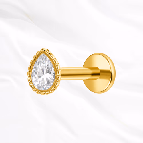 Labret push-in en titane doré L’Obélisque, zircon taille poire serti clos dans une monture bordée de fines billes
