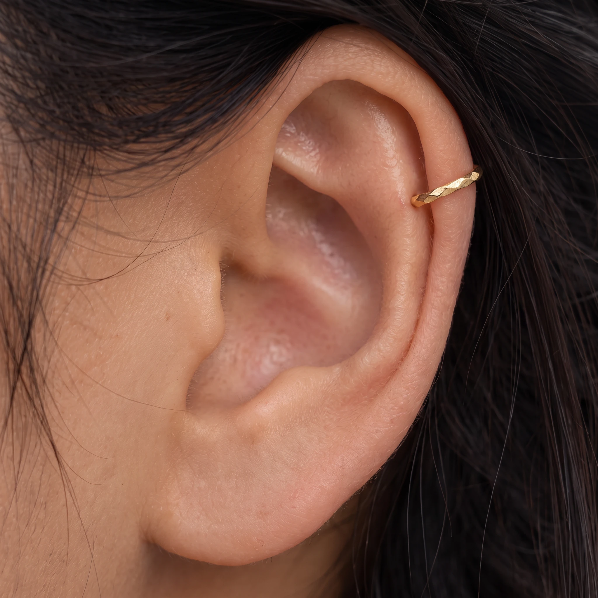 Piercing Le Torsadé en titane doré porté à l'oreille