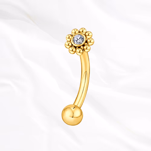 Piercing banane en titane doré Le Tournesol, couronne de billes de titane autour d’un zircon, montée au sommet d’une tige courbée